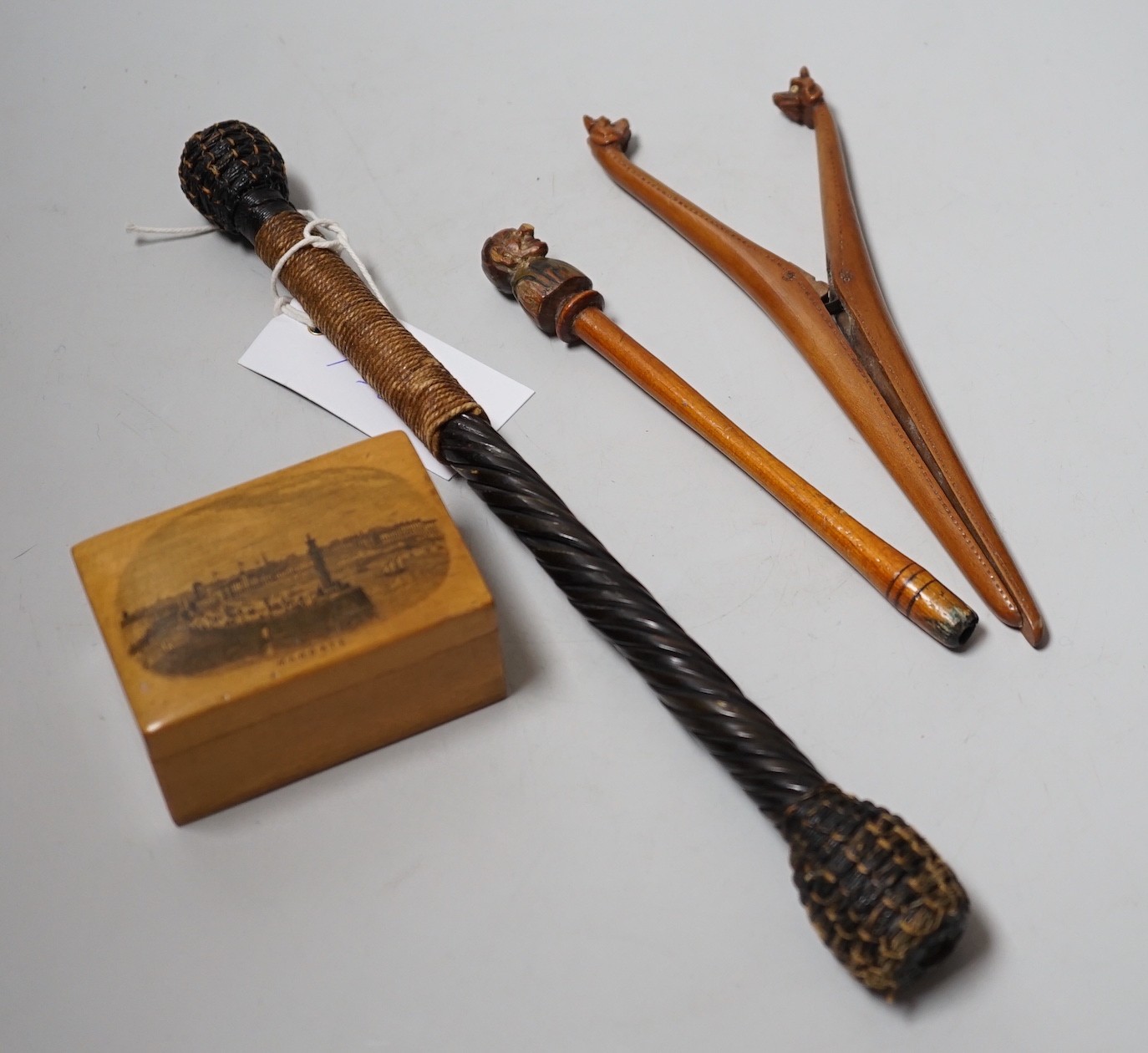 A pair of novelty treen glove-stretchers, 19cm, a similar pipe, a mauchline box and a 19th century beater